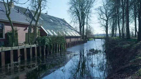 Tracking pov shot along a tranquil dutch canal in winter Видео 331188724