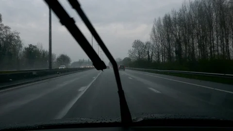 Tracking POV shot of driver driving in highway under heavy rain Stock Footage 98010599