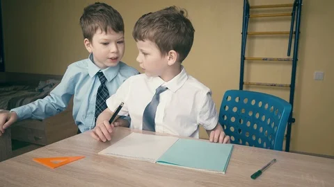 Tracking: Pupils do homework, write numbers in notebooks, help each other Stock Footage 105098192
