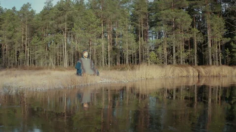 TRACKING REVERSE shot of an ice bather doing conscious breathing by a Video stock 166442504