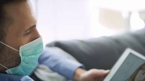 Tracking right video of patient having video conference with doctor.  Stock Footage 128853239