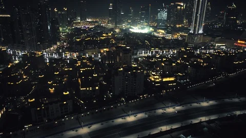 Tracking right while panning up at 100m from over Downtown Dubai, to reveal Burj Stock Footage 98983438