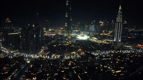 Tracking right while panning up at 150m from over Downtown Dubai, to reveal Burj Stock Footage 98983042
