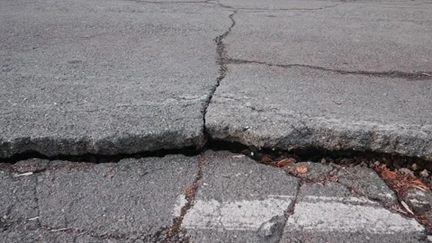 Tracking shoot of a deep fault on the highway near the road markings Stock Footage 181439330