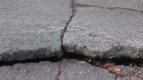 Tracking shoot of a deep fault on the highway near the road markings Stock Footage 245179310