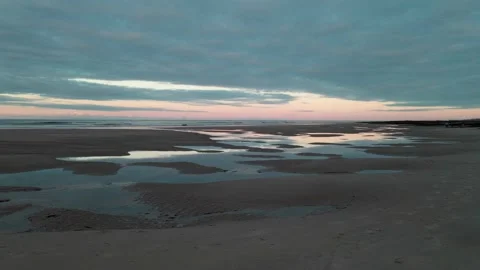 Tracking shot across empty beach at sunset 動画素材 138437974