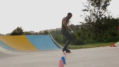 Tracking shot of active rollerblading man in slow motion with inline skating, Stock Footage 110859360