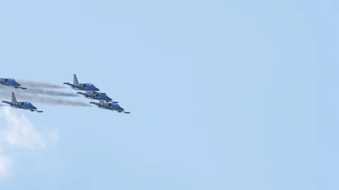 Tracking shot of airplanes formation performing aerobatics on the sky at airshow Stock Footage 123295374
