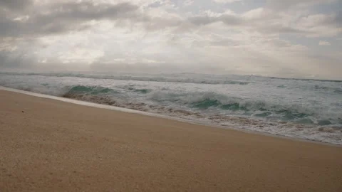 Tracking Shot Along Beach with Light Rays in Dramatic Sky Above 4K Stock Footage 267048617