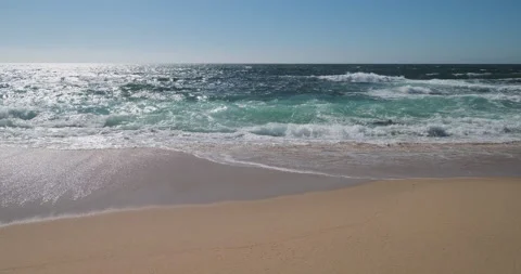 Tracking shot along beautiful sandy beach parallel to shore Stock Footage 132017066