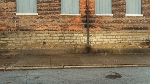 Tracking shot along brick wall in industrial area Stock-Footage 100416528