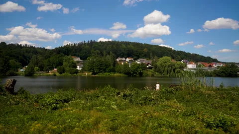 A tracking shot along idyllic landscape with lakeside houses in Germany Stock Footage 199531331