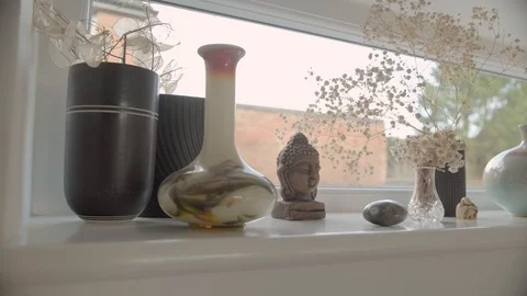 Tracking shot along letterbox window sill with vases and ornaments (2 of 2) Stock Footage 127269830