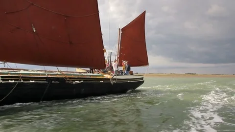 Tracking shot along side of Thames sailing barge at sea Stock Footage