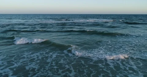 Tracking shot along waves hitting the shore drone aerial 4K Stock Footage 111415861