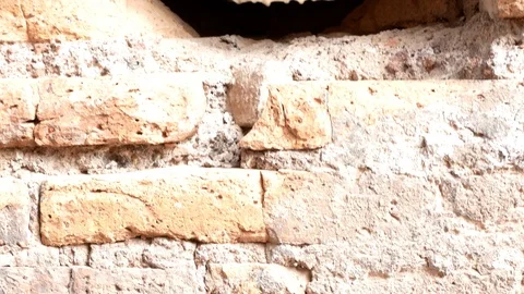 Tracking shot on an ancient Roman wall with a hole in the middle, in the center Stock-Footage 89901728