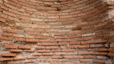 Tracking shot on an ancient round shaped wall in central Rome Stock Footage 89906908