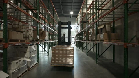 Tracking shot of approaching forklift driver in warehouse / American Fork, Utah, Stock-Footage 275541549