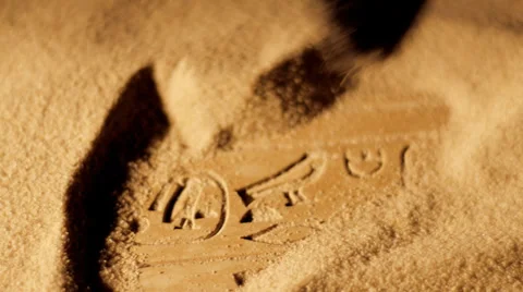 Tracking shot of archaeologist brushing sand from ancient Egyptian hieroglyphics Stock Footage 35272924