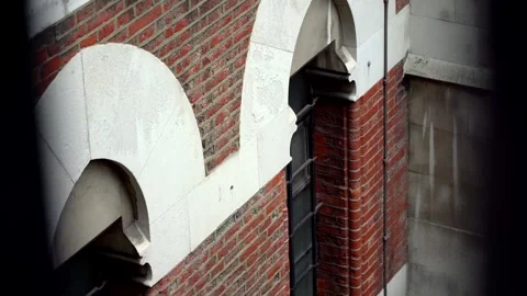 Tracking Shot of Barred Windows Through Gates at Royal Courts of Justice, London Stock Footage 286136257