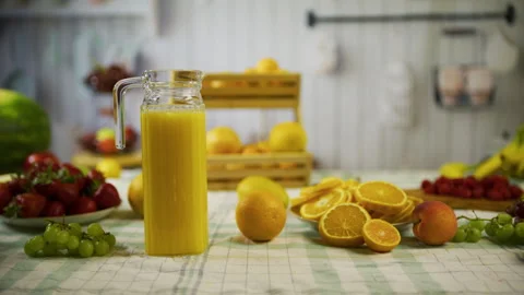 Tracking shot of beautiful, fresh oranges and pitcher of juice in kitchen Stock Footage 341187589