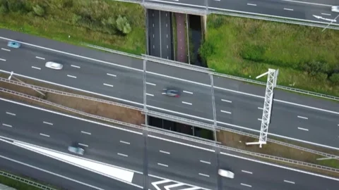 A tracking shot of a bicycle rider going underneath bridges on the highway Stock Footage