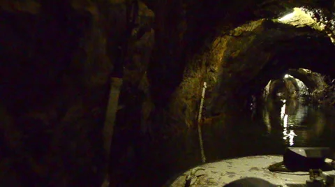 Tracking shot on boat through dark cave system in czech republic Stock Footage 40022628