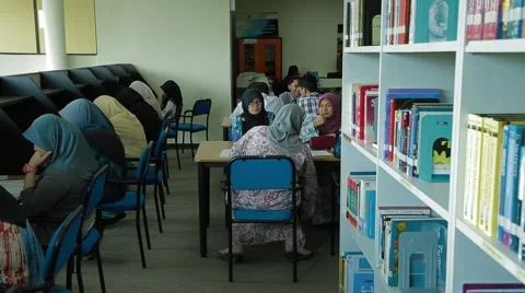 Tracking Shot from Book Shelf to Studying Students in Allianze Library Stock Footage 49388024