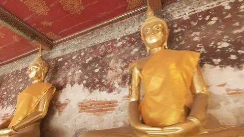 Tracking Shot of Buddha Statues Sitting at Wat Suthatthepwararam Stock Footage 100403903