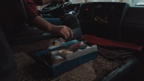 Tracking shot of bus driver counting money during riding. Safety on a road.   Video stock 122300365