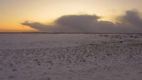 Tracking shot camera moves in beautiful empty landscape with snow during sunset Stock Footage 94133819