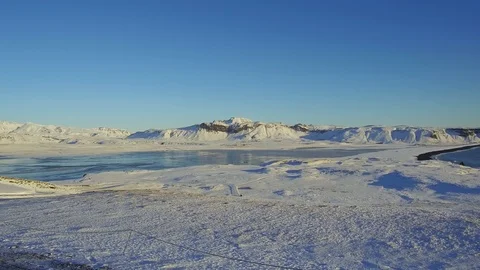 Tracking shot camera moves in a beautiful landscape with frozen lake, mountain Stock Footage 95307149