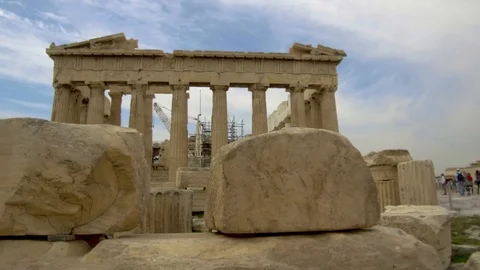 Tracking shot camera moves behind stones of ancient parthenon acropolis Stock Footage 92437859