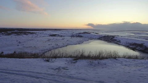 Tracking shot camera moves fast in snowy landscape with frozen lakes and rivers Stock Footage 94133917