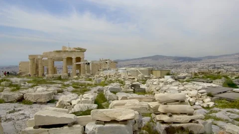 Tracking shot camera moves slowly around ruins of Acropolis Propylaea entryway Stock Footage 92437623