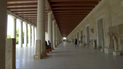 Tracking shot camera moves from Stoa of Attalos in Athensto the flag of Greece Stock Footage 92439018
