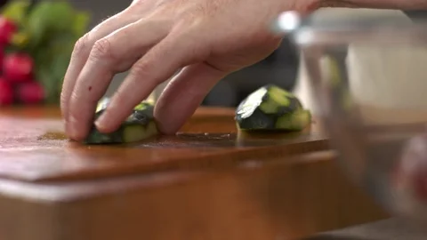 Tracking shot of chef slicing fresh cucumber Stock Footage 92191359