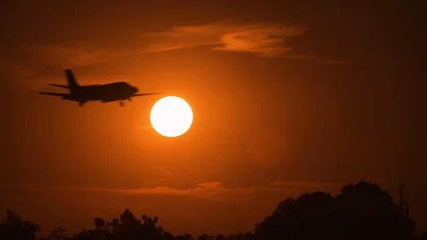 Tracking shot close up view of an airplane silhouette flying above the sun Stock Footage 123295519