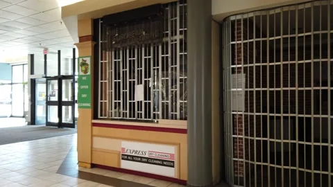 Tracking shot of closed stores in a mall Stock Footage 143986051