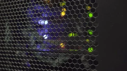 Tracking shot. Colored computer server lights flashing behind rack cabinet Stock Footage 136484714