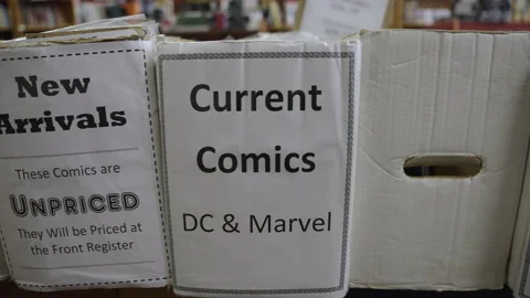 Tracking shot comic book boxes store slow motion 4K Stock Footage 171973104