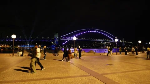 Tracking shot crowds and VIVID Sydney Harbour Bridge 6K Stock Footage 311144087