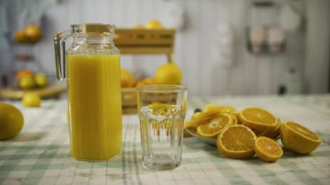Tracking shot on delicious display of oranges and pitcher of juice Stock Footage 341237791