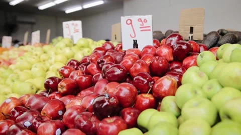 Tracking shot of different kind of ripe fruit on shelf in market. Red, yellow Stock Footage 170611867