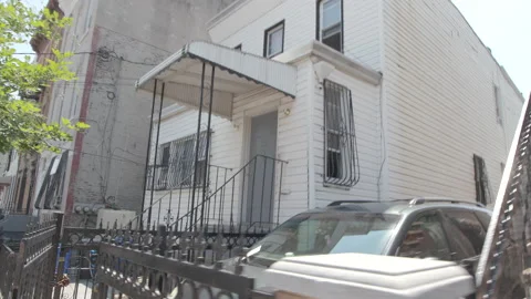 Tracking shot down sidewalk in East New York, Brooklyn.   4K Stock Footage 141008226