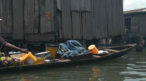 Tracking shot to drinking water delivery, Makoko floating slum Stock Footage 38386942