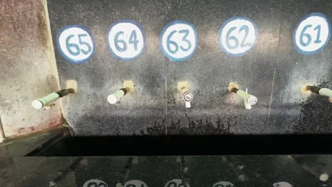 Tracking shot of dripping drinking water taps in public facility Stock Footage 340975428