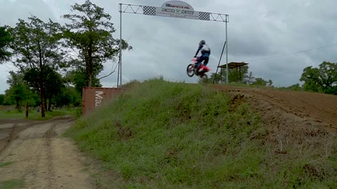 Tracking Shot Of A Fast Young Motocross Racer Kid Flying Through The Finish Line Stock Footage