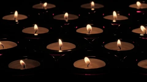 Tracking shot of flickering tealight candle flames Video stock 73955260