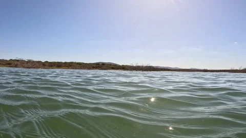 A tracking shot of gentle waves created by a moving boat Stock Footage 288218090